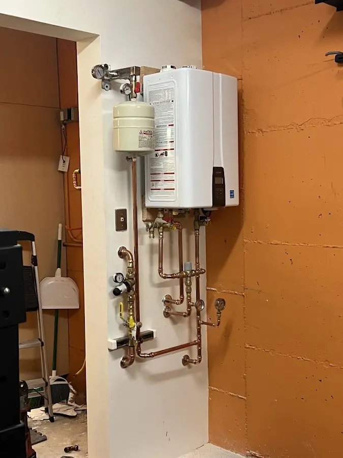 Plumbing technician inspecting water heater connections in Buellton